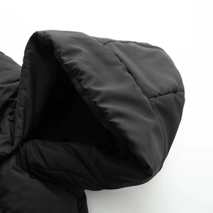 Detailed close-up of a black padded hood with durable windproof stitching on a jacket