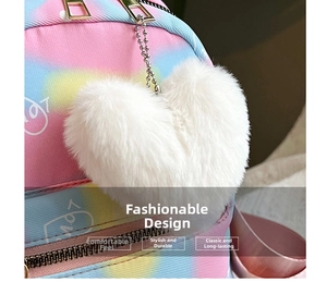 Close-up of fluffy white heart pompom keychain on a gradient macaron backpack