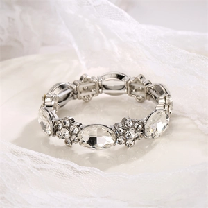 Detail of elegant silver alloy bracelet with sparkling oval crystal floral clusters