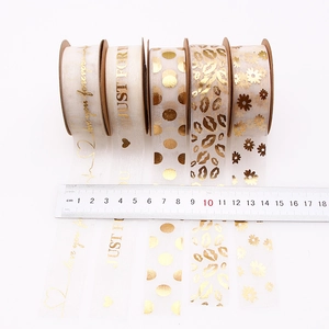 Five rolls of 25mm gold-stamped organza ribbons with love patterns and text