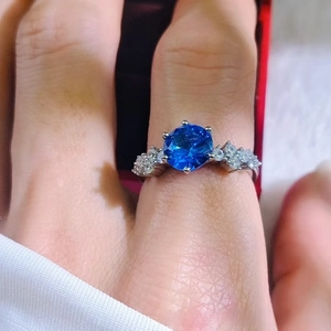 Detailed view of luxury ring with large blue sapphire and brilliant side accents