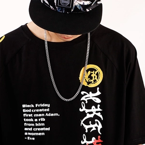 Detail of custom calligraphy print and badge on a black men's cotton crewneck t-shirt