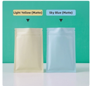 Macro detail of matte yellow and sky blue aluminum foil stand up pouches with zippers
