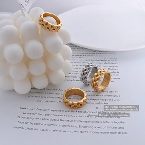 Modern gear-textured titanium steel rings in gold and silver finish on magazines