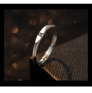 Macro detail of S925 silver Taurus zodiac sign engraved on minimalist open ring