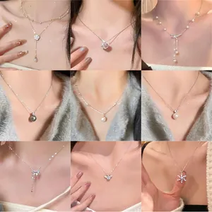 Detailed grid of silver necklaces featuring pearl, butterfly, and heart-shaped pendants