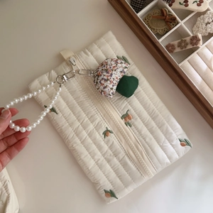 Quilted white cotton pouch with orange fruit embroidery and a pearl beaded handle