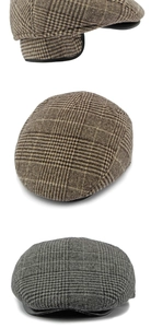 Detail view of winter flat caps in brown and grey plaid textured wool fabric