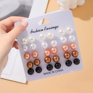 Set of 12 pairs of colorful imitation pearl stud earrings on a fashion card display