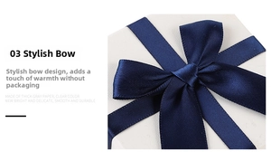 Detail of white textured jewelry box with navy blue satin bow made of thick paper