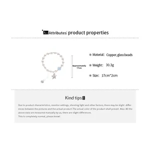 Detailed view of beaded bracelet with blue glass bead and engraved star pendant