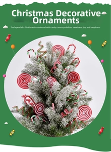 Close-up of red and green candy cane ornaments hanging on a snowy Christmas tree branch