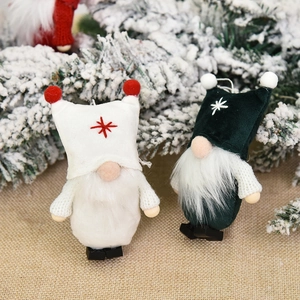 Christmas faceless gnome ornaments with plush hats and star embroidery on pine branches