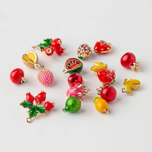 Assorted gold-plated fruit charms collection for DIY jewelry making on white background