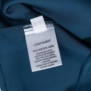 Detailed care label showing washing instructions for the navy blue satin strapless dress