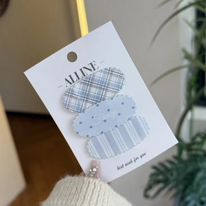 Three-piece hair clip set featuring blue plaid, heart, and stripe patterns on display card