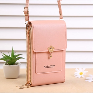 Detail of pink crossbody phone bag with floral hardware and multi-layer zipper structure