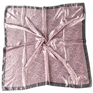 Detailed view of pink paisley square scarf with smooth satin texture and floral pattern