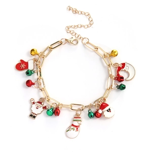 Detailed view of Christmas charm bracelet with Santa, snowman and bell pendants