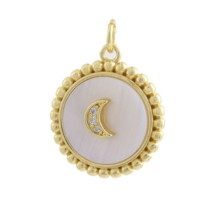 Detailed macro of gold bead pendant with mother of pearl inlay and crescent moon design