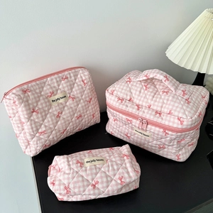 Three-piece set of pink plaid quilted cosmetic bags in various sizes for travel