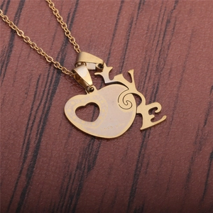 Polished gold stainless steel heart LOVE pendant necklace on a wooden background