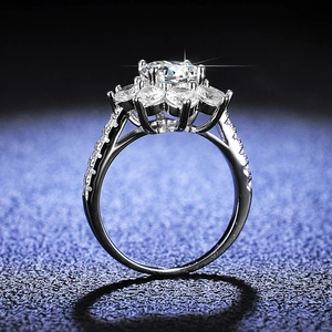 Exquisite silver sunflower moissanite ring with a brilliant round center stone on blue background