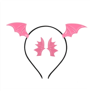 Close-up of pink bat wing headband with glossy finish for Halloween party hair accessory