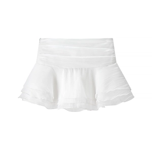 Detail of white high waisted mini skirt featuring tiered ruffle layers in lightweight chiffon
