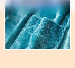 Detail of the thick teal flannel bathrobe cuff featuring a durable diamond weave pattern