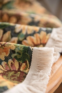 Close-up of thick sunflower jacquard fabric with beige decorative fringe tassels