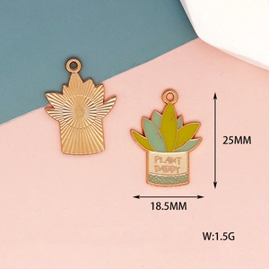 Detailed view of enamel succulent plant charms with Plant Daddy text in rose gold finish