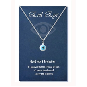 Detail view of the silver evil eye amulet necklace on a blue decorative card