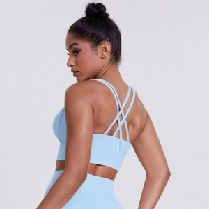 Detail of light blue sports bra with criss-cross back design and elastic fabric texture