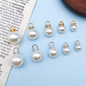Assorted gold and silver imitation pearl charms with rhinestones in multiple sizes