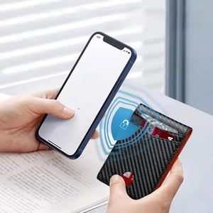 Detail of slim carbon fiber wallet with orange edges showing RFID blocking protection
