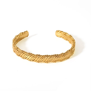 Close-up of 18K gold-plated stainless steel cuff featuring a twisted rope texture