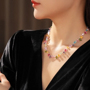 Macro shot of silver-tone necklace with multi-color teardrop and oval zircon gemstones
