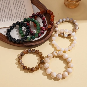 Retro colorful geometric acrylic beaded bracelets displayed on a vintage book page