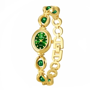 Detail of gold quartz watch featuring green oval dial and jewel-like link bracelet