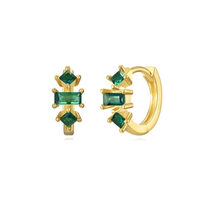 Detail view of gold hoop earrings set with emerald green cubic zirconia stones