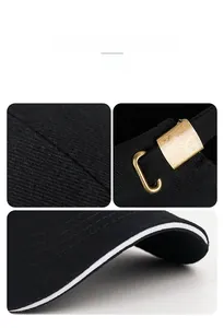 Detail of black cotton baseball cap showing copper buckle and sandwich brim design
