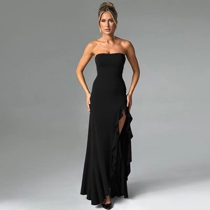 Detail of elegant black strapless evening dress featuring a high side slit with ruffle edges