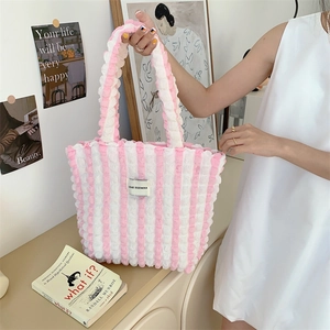 Detailed texture of pink and white striped bubble gauze tote bag with brand label