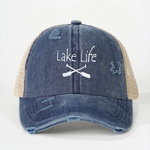 Detailed embroidery of Lake Life and paddles on a vintage distressed trucker cap