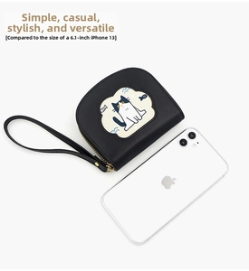 Mini cat wallet shown beside iPhone 13 for scale comparison and size demonstration
