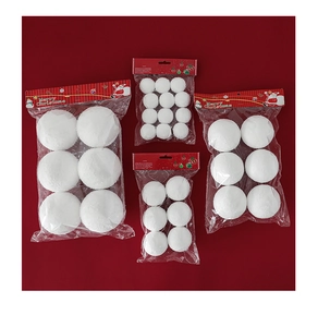 White Christmas foam snowballs in various sizes displayed on a vibrant red background