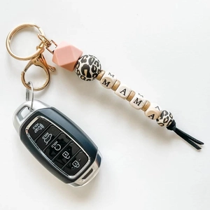 Detail of pink silicone beads and MAMA letter wooden beads on a stylish keychain