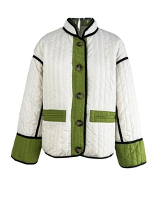Detail of color-block quilted jacket with olive pockets and cream vertical stitching