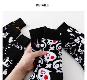 Detail shot of black knitted Halloween socks featuring ghost and skull patterns
